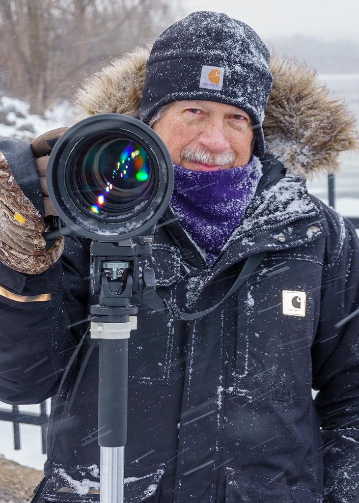 Ed Guarente photographing wildlife with his Nikon camera during a snowy Central New York winter.